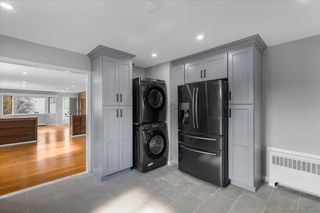 a kitchen with stainless steel appliances granite countertop a refrigerator and a stove top oven