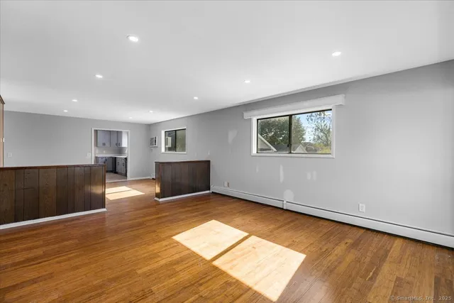 a view of a room with wooden floor and window