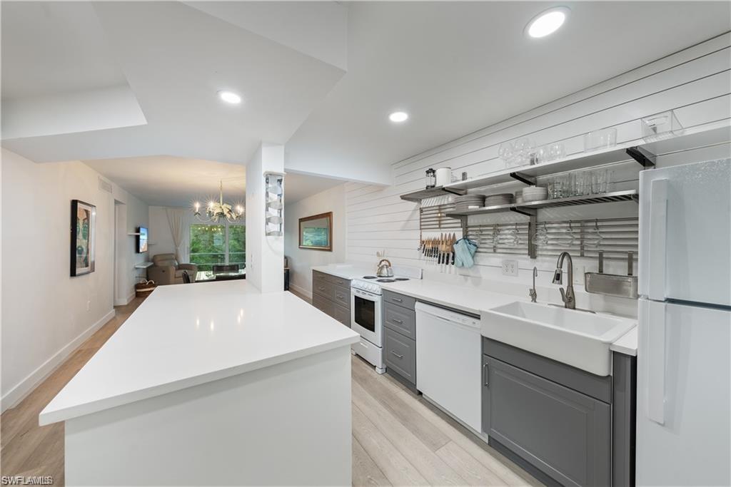 72 7th Street South, Unit 310 Naples, FL 34102 - Photo 2 of 20 a large kitchen with kitchen island a sink stainless steel appliances and cabinets