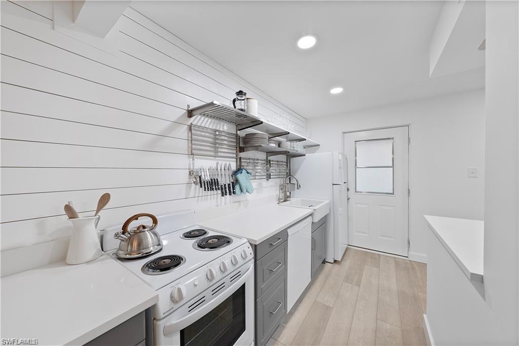 72 7th Street South, Unit 310 Naples, FL 34102 - Photo 3 of 20 a kitchen with a sink and a stove top oven