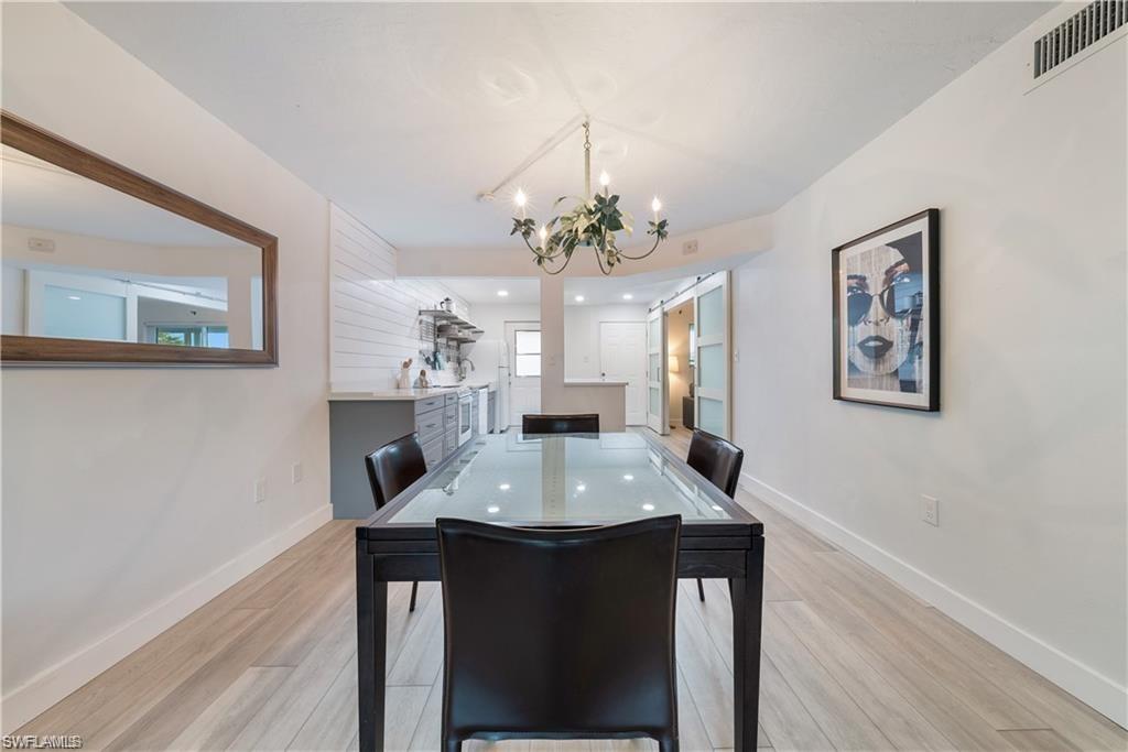 72 7th Street South, Unit 310 Naples, FL 34102 - Photo 6 of 20 a view of a dining room with a table and chairs