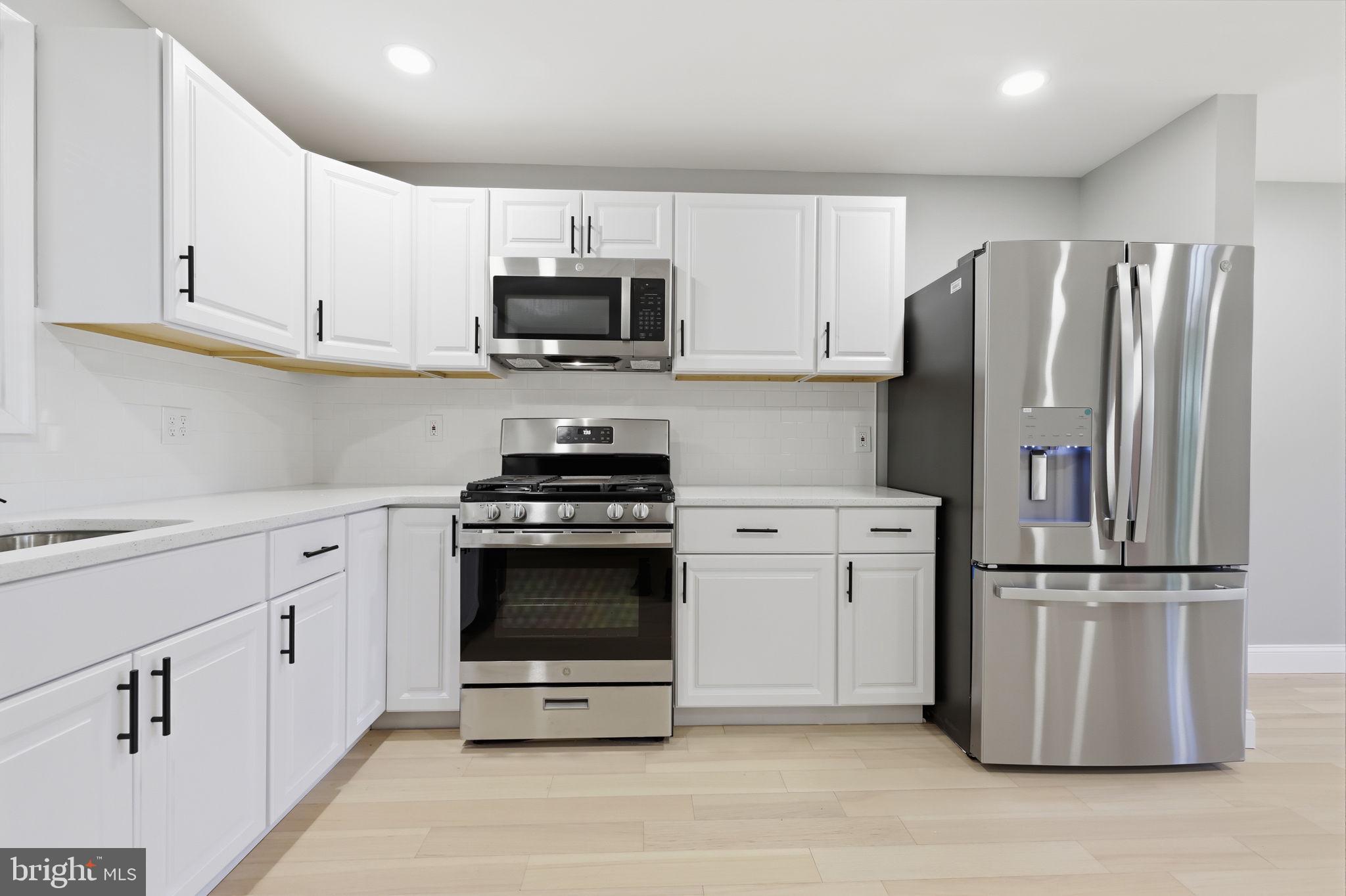 340 West Broad Street Hatfield, PA 19440 - Photo 13 of 55 a kitchen with white cabinets and stainless steel appliances