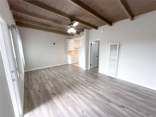 a view of hallway with wooden floor