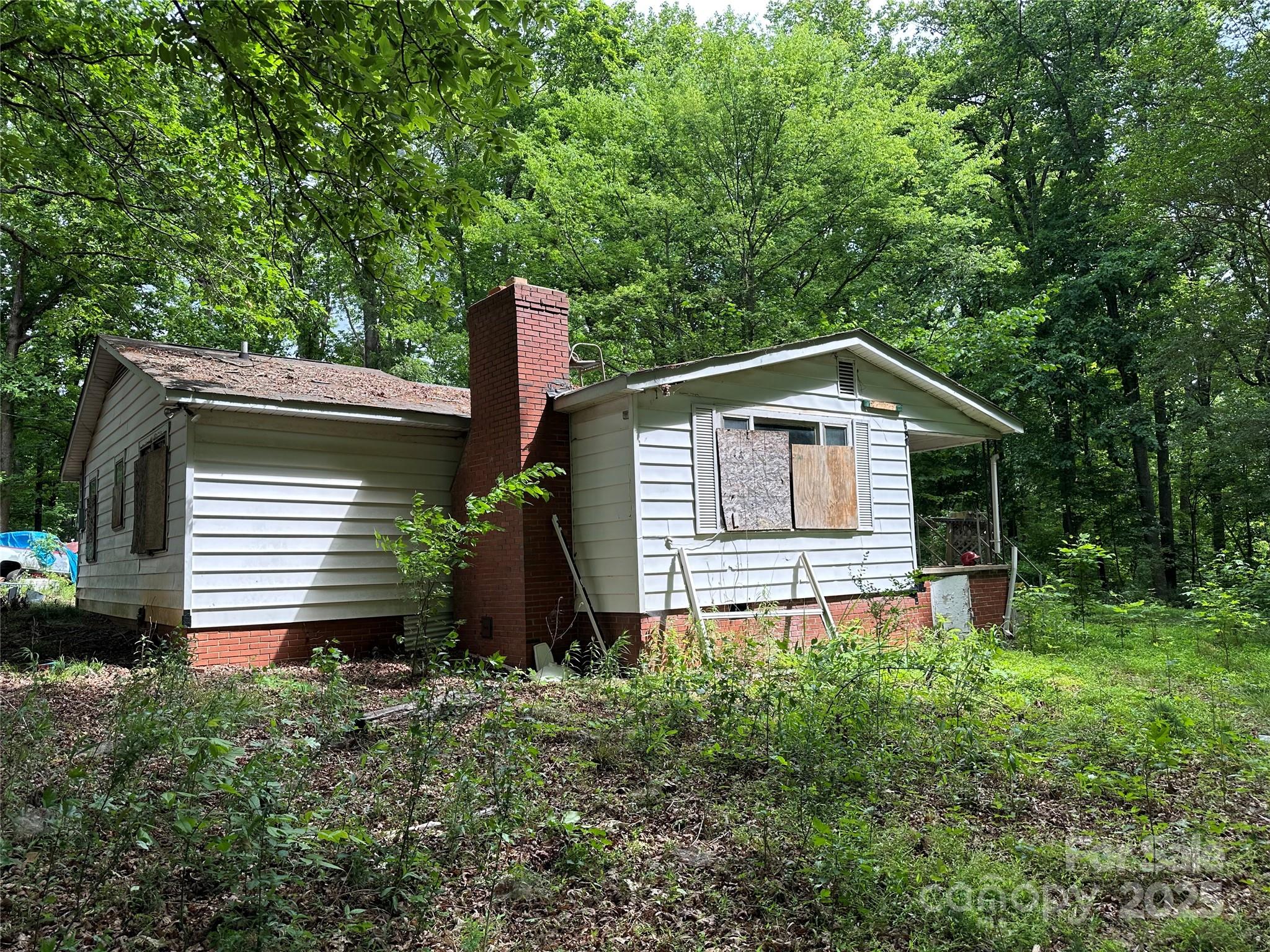 455 Running Brook Road Midland, NC 28107 - Photo 1 of 6 a house with lots of trees in the background