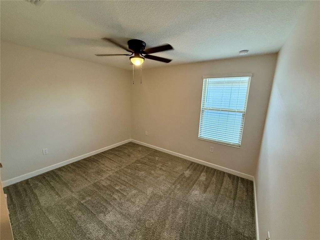 1421 Happy Bird Lane Winter Springs, FL 32708 - Photo 16 of 16 an empty room with a window and a ceiling fan