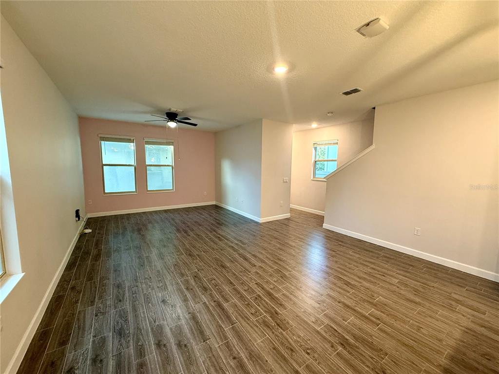 1421 Happy Bird Lane Winter Springs, FL 32708 - Photo 4 of 16 an empty room with wooden floor and windows
