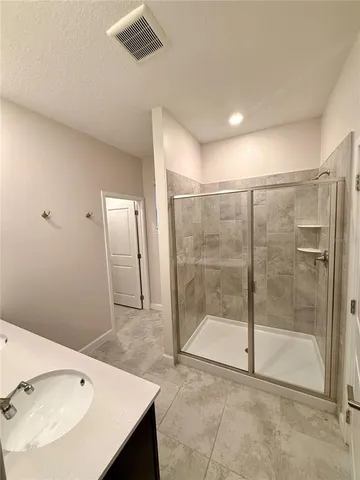 a bathroom with a shower and a sink