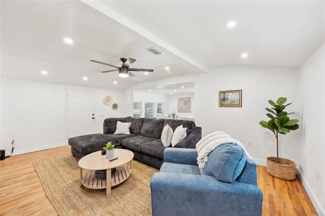 a living room with furniture and a potted plant