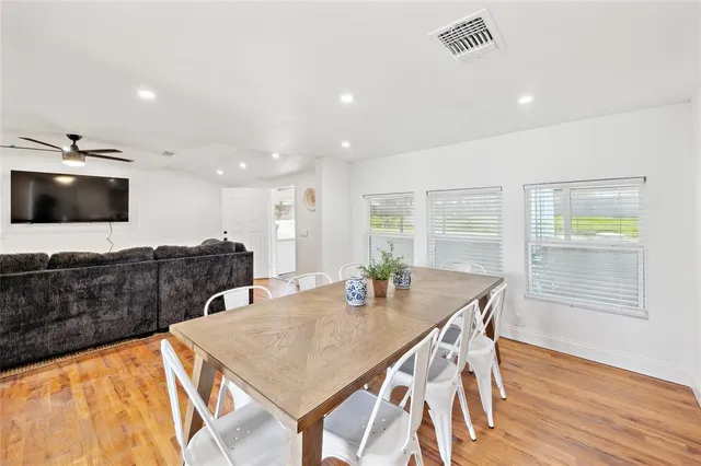 a view of a dining room with furniture and wooden floor