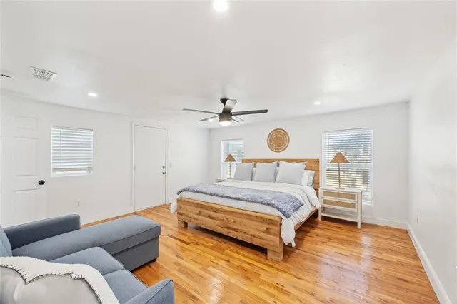 a bedroom with a bed and a ceiling fan