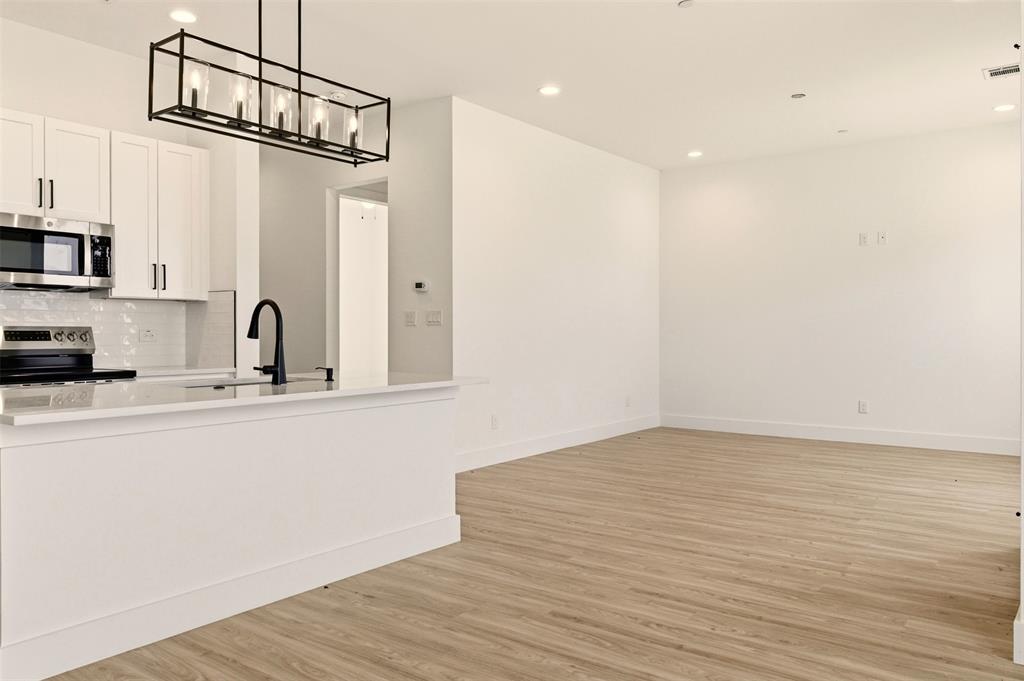 8902 Lowell Street Rowlett, TX 75089 - Photo 5 of 32 a view of a room with wooden floor