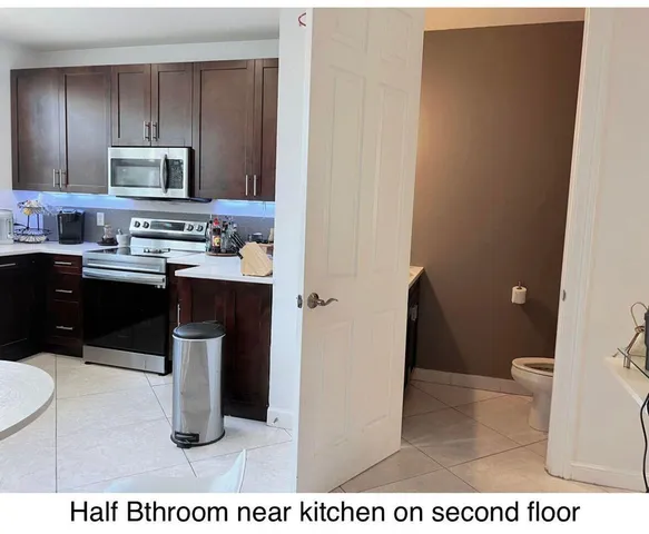 a kitchen with a sink a stove a microwave and cabinetry