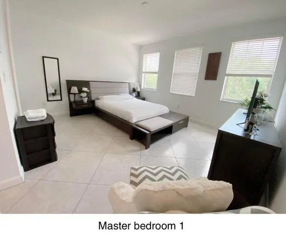 a bedroom with a bed and a couch