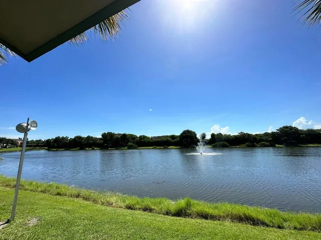 a view of a lake with houses in the background