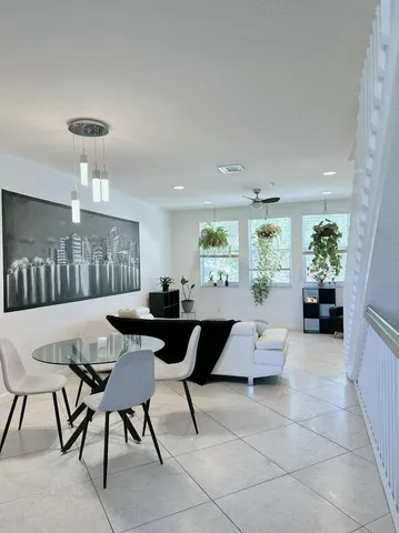 a view of a dining room with furniture and a chandelier
