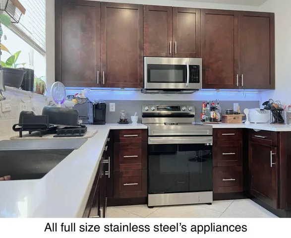 a kitchen with a sink stove and microwave