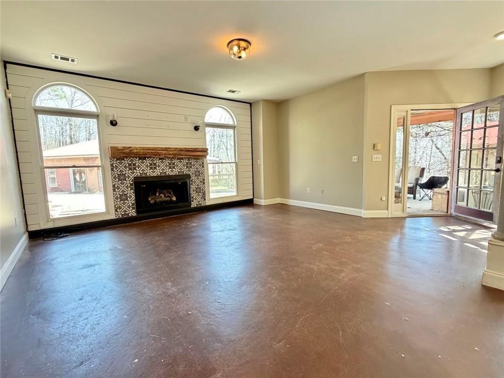 9011 High Point Road Villa Rica, GA 30180 - Photo 15 of 68 an empty room with windows fireplace and wooden floor