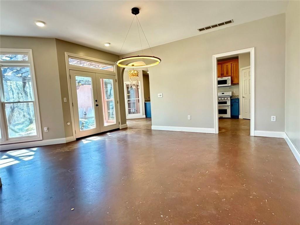 9011 High Point Road Villa Rica, GA 30180 - Photo 17 of 68 an empty room with wooden floor chandelier and windows
