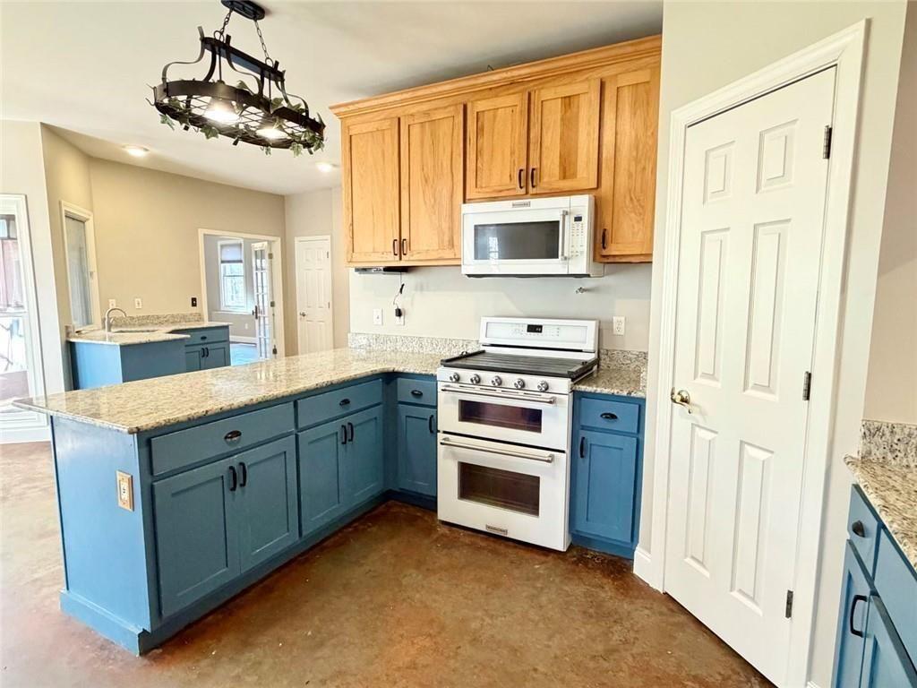 9011 High Point Road Villa Rica, GA 30180 - Photo 19 of 68 a kitchen with stainless steel appliances white cabinets and a sink