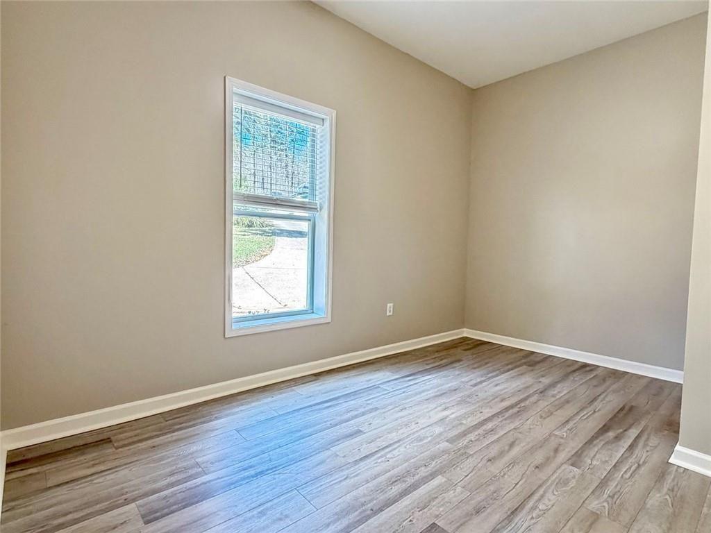 9011 High Point Road Villa Rica, GA 30180 - Photo 48 of 68 a view of an empty room with wooden floor and a window