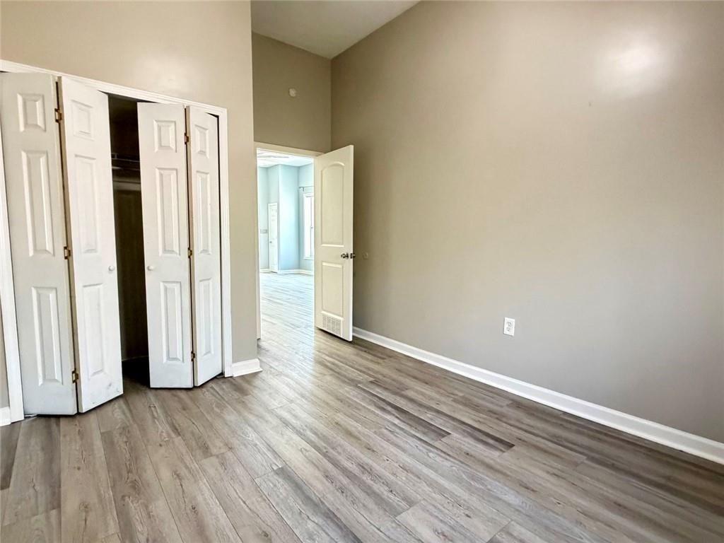 9011 High Point Road Villa Rica, GA 30180 - Photo 51 of 68 an empty room with wooden floor and entrance door