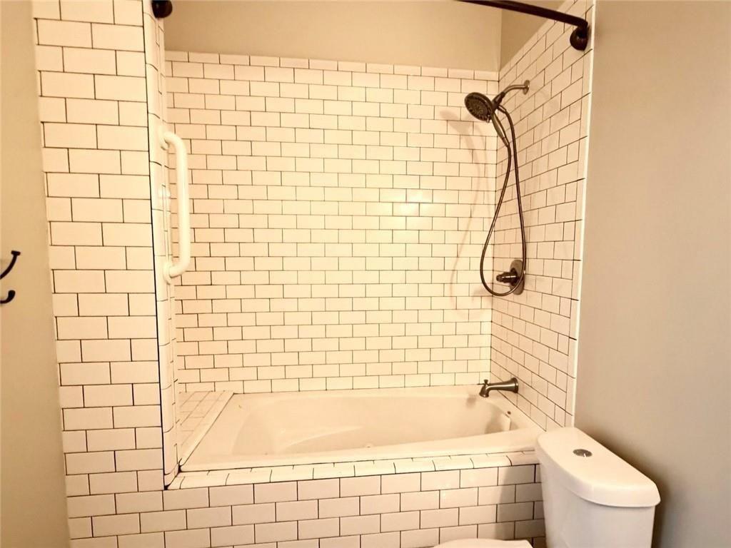 9011 High Point Road Villa Rica, GA 30180 - Photo 52 of 68 a bathroom with a shower and a toilet