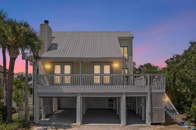 a roof deck with table and chairs plants with wooden fence