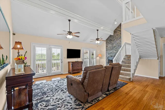 a living room with furniture a flat screen tv and a fireplace