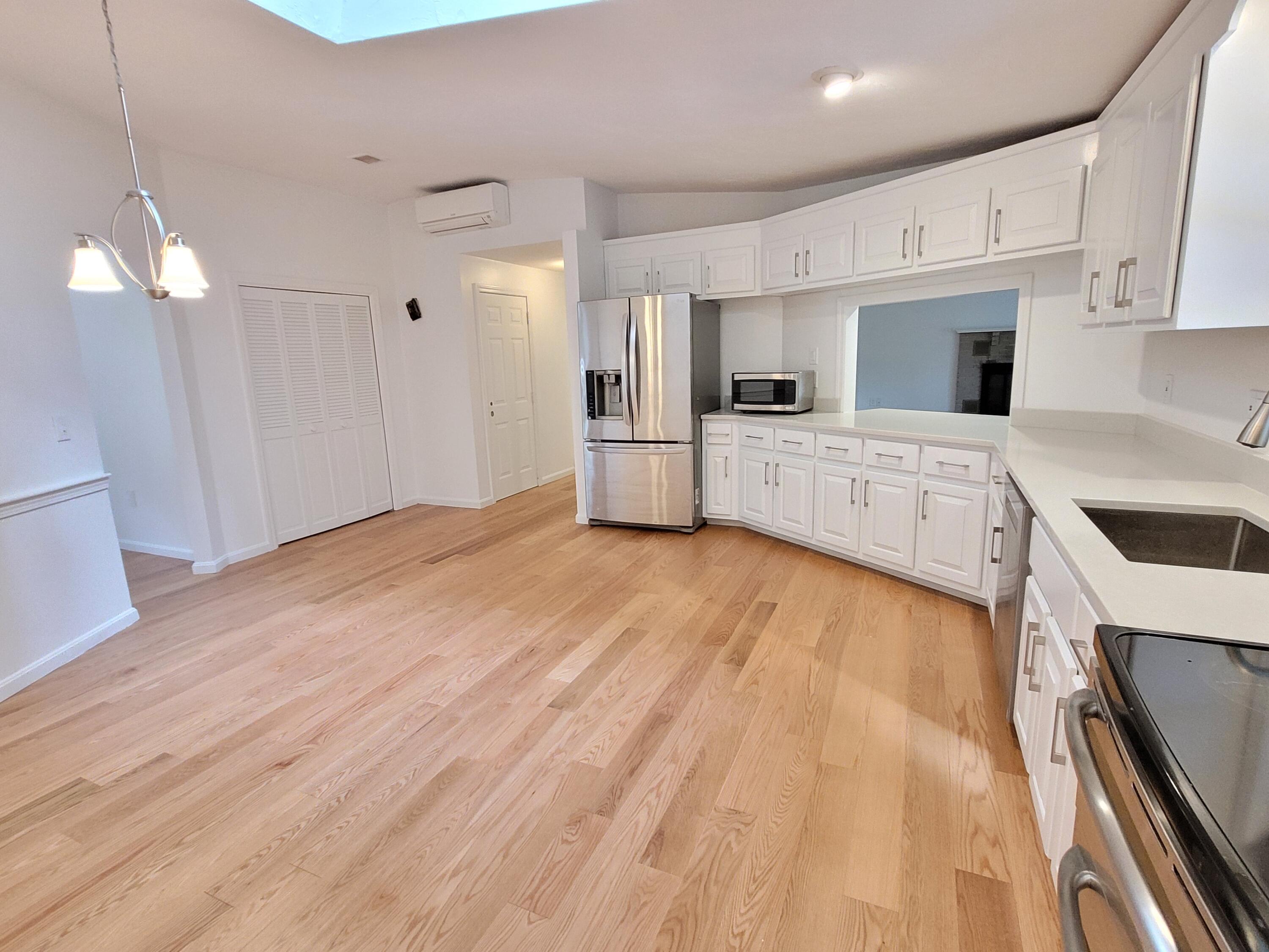 130 Foxglove Road Centerville, MA 02632 - Photo 15 of 65 a large white kitchen with cabinets a sink and a stove
