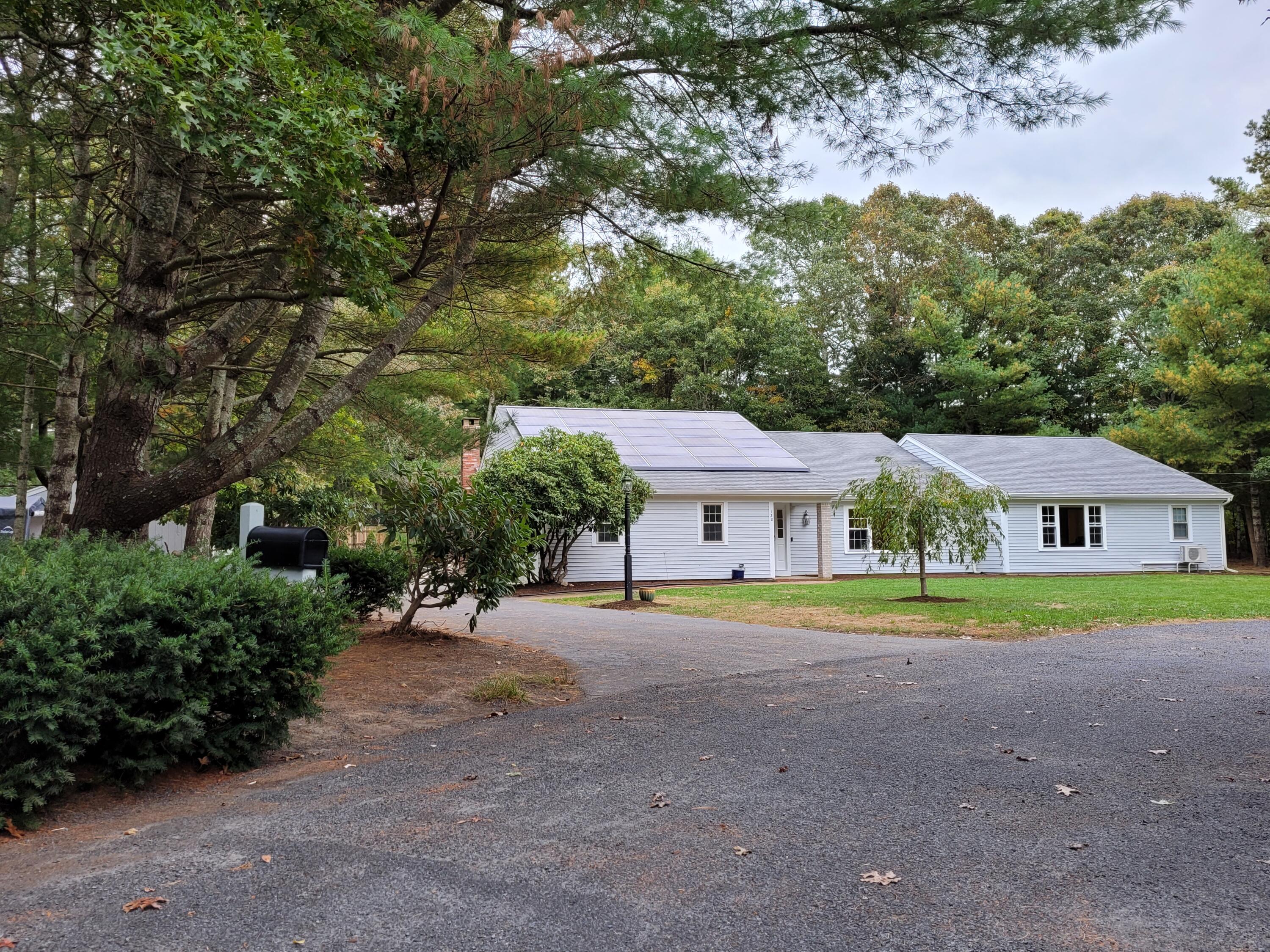 130 Foxglove Road Centerville, MA 02632 - Photo 59 of 65 a front view of a house with a yard and trees