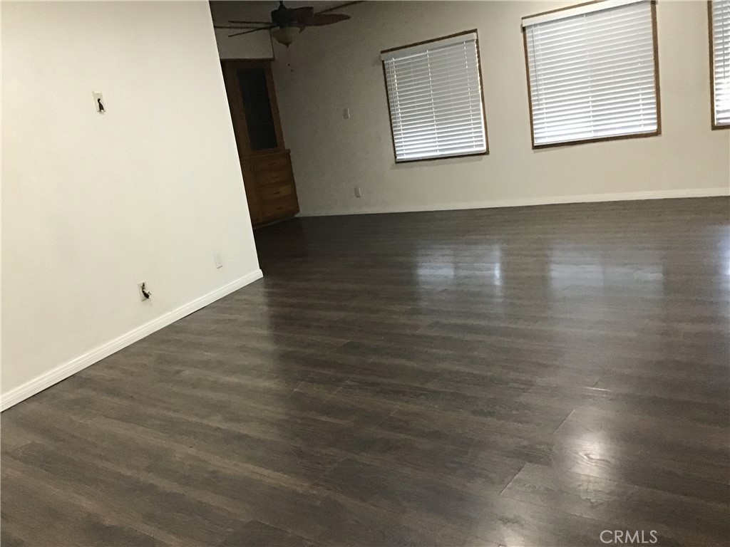 7271 Katella Stanton, CA 90680 - Photo 13 of 43 an empty room with wooden floor and windows