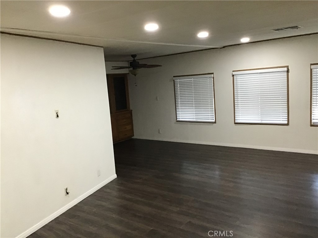 7271 Katella Stanton, CA 90680 - Photo 14 of 43 an empty room with wooden floor and windows