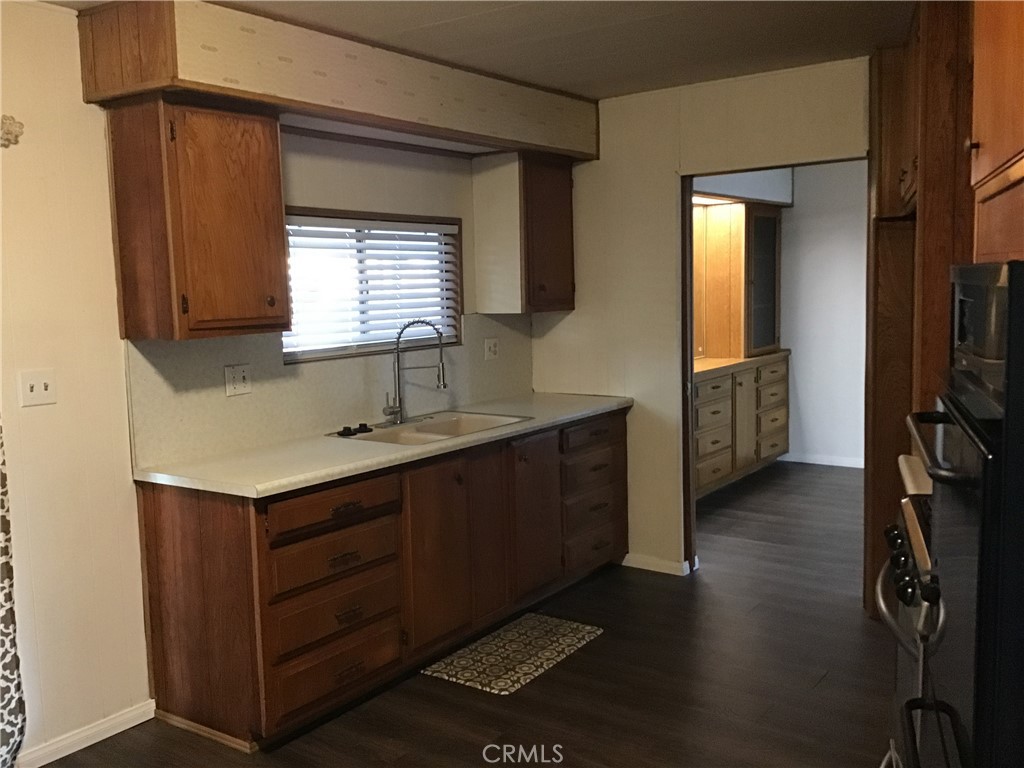 7271 Katella Stanton, CA 90680 - Photo 16 of 43 a kitchen with a sink cabinets and wooden floor