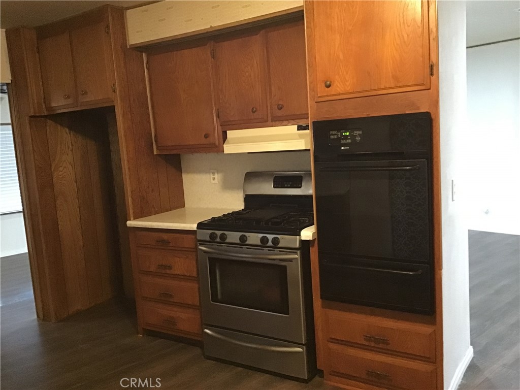 7271 Katella Stanton, CA 90680 - Photo 18 of 43 a kitchen with stainless steel appliances wooden cabinets and a stove