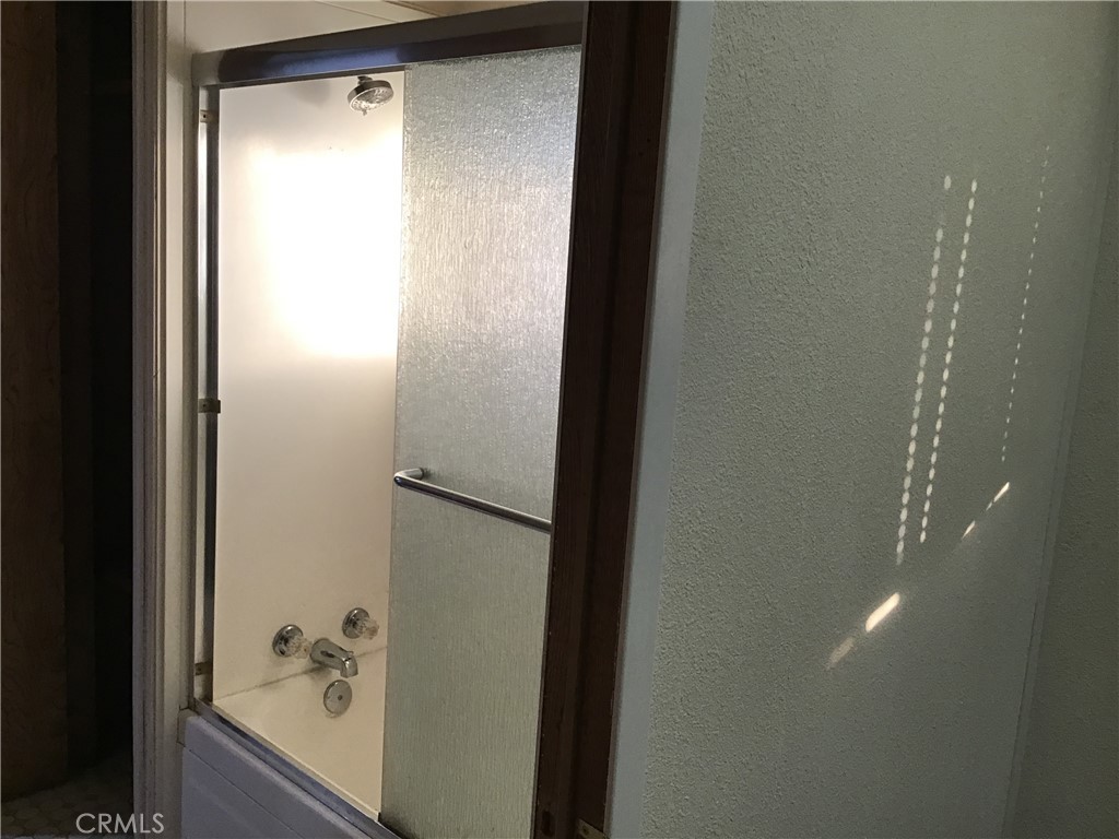 7271 Katella Stanton, CA 90680 - Photo 26 of 43 a bathroom with a glass shower door