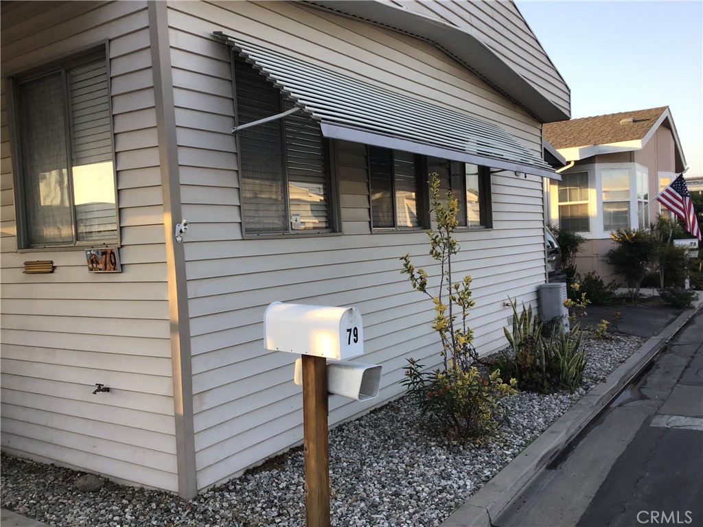 7271 Katella Stanton, CA 90680 - Photo 3 of 43 a view of a house with a yard and potted plants