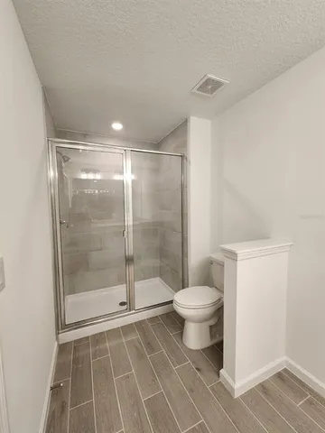 a bathroom with a shower and a toilet