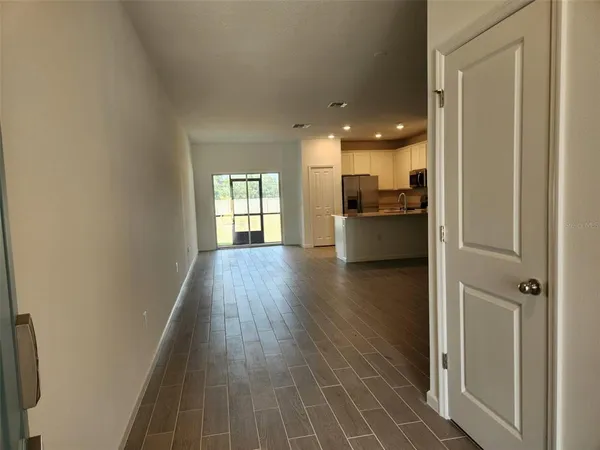 a view of a room with wooden floor and windows