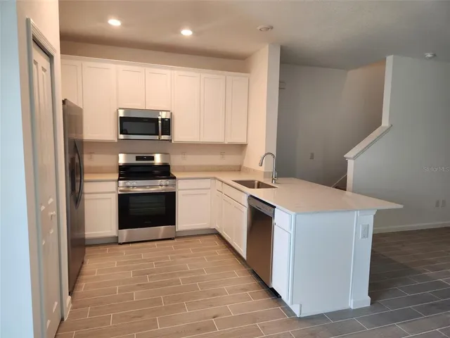 a kitchen with a stove a sink and a refrigerator