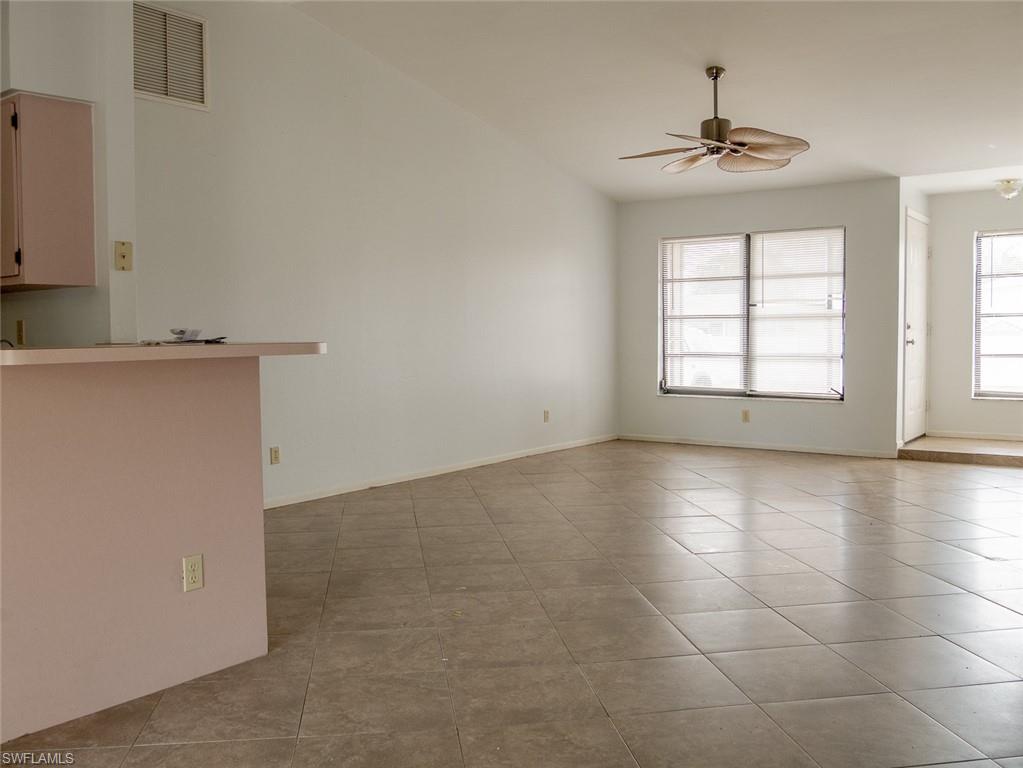 19029-19031 Holly Road Fort Myers, FL 33967 - Photo 8 of 15 Empty room with light tile patterned flooring and ceiling fan