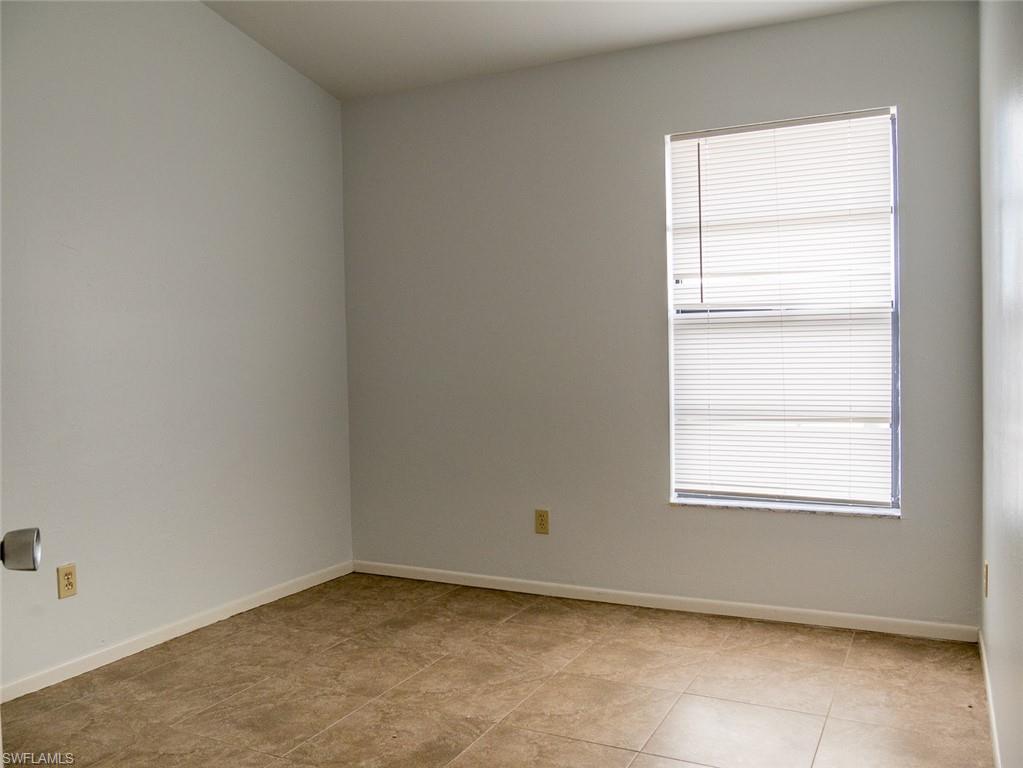 19029-19031 Holly Road Fort Myers, FL 33967 - Photo 10 of 15 Unfurnished room featuring baseboards and light tile patterned floors