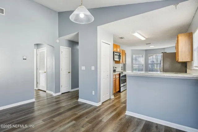a view of a kitchen cabinets and wooden floor