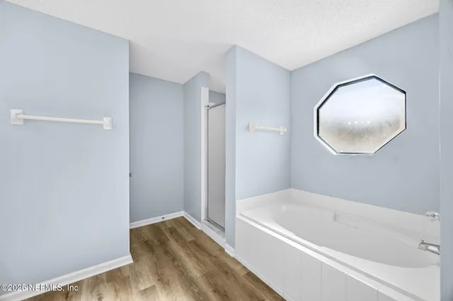 a bathroom with a tub and shower