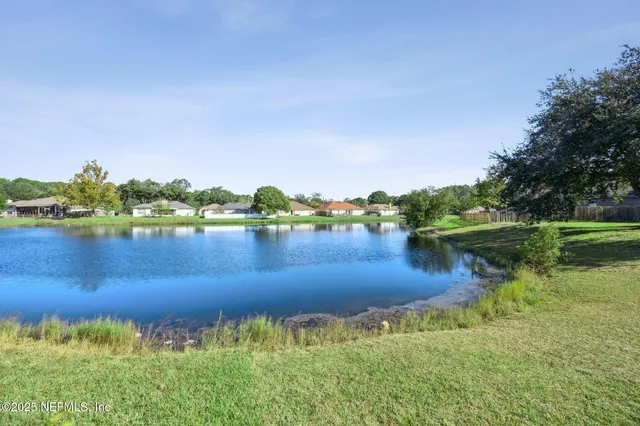 a view of a lake with houses in the back