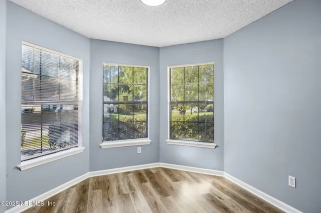 a view of an empty room with windows