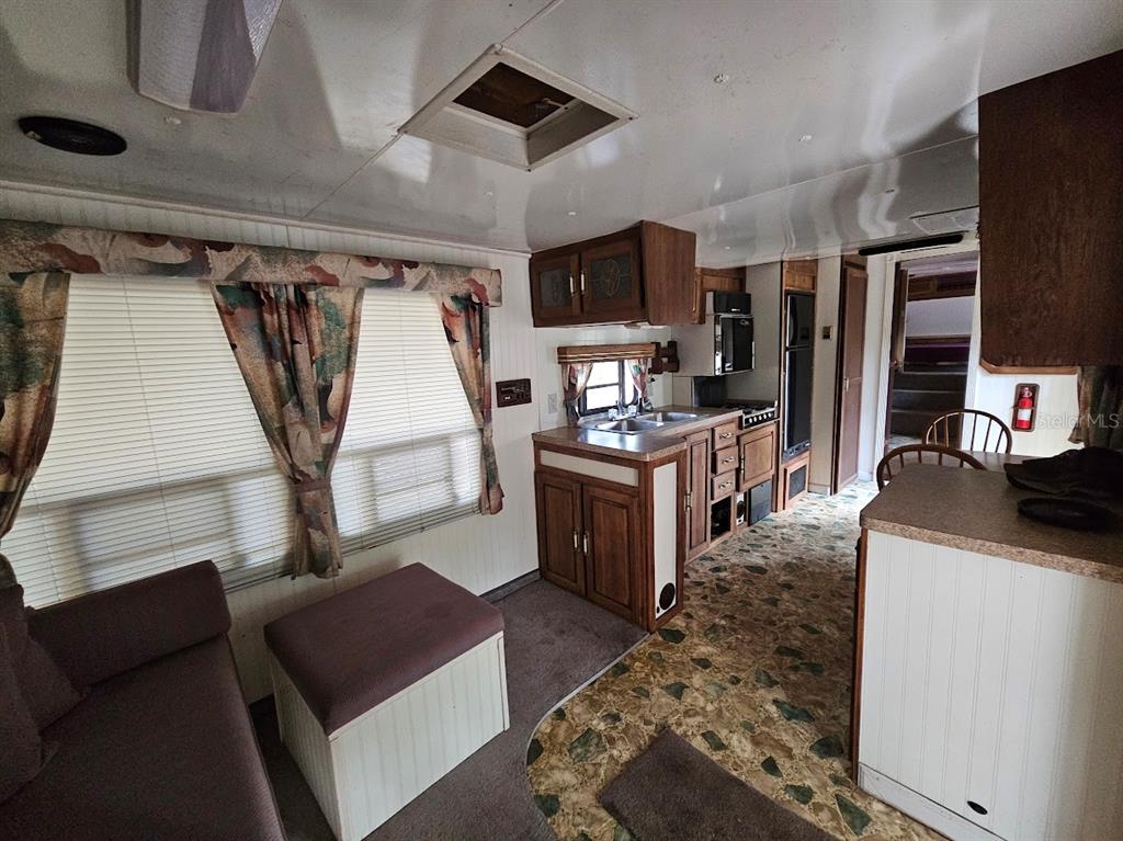 804 Shell Harbor Road Pierson, FL 32180 - Photo 3 of 27 a room with furniture a flat screen tv and a refrigerator