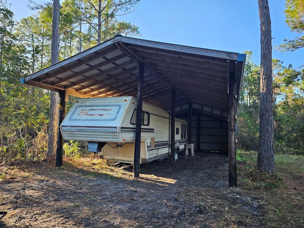 804 Shell Harbor Road Pierson, FL 32180 - Photo 7 of 27 a view of a wooden house with a yard