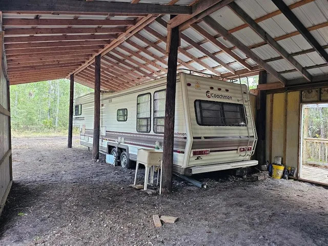a view of a porch with furniture and a yard