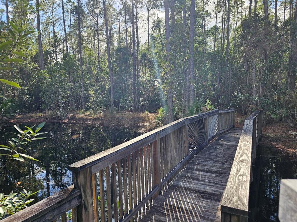 804 Shell Harbor Road Pierson, FL 32180 - Photo 10 of 27 a balcony with wooden fence and trees