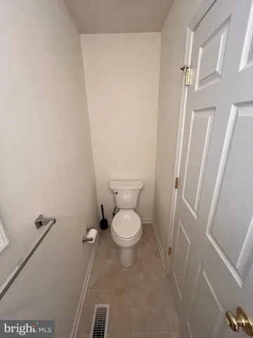 a white toilet sitting next to a white sink